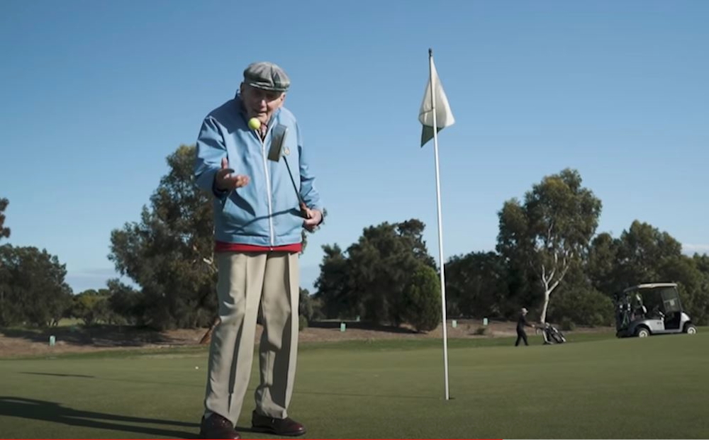 Old man plays golf